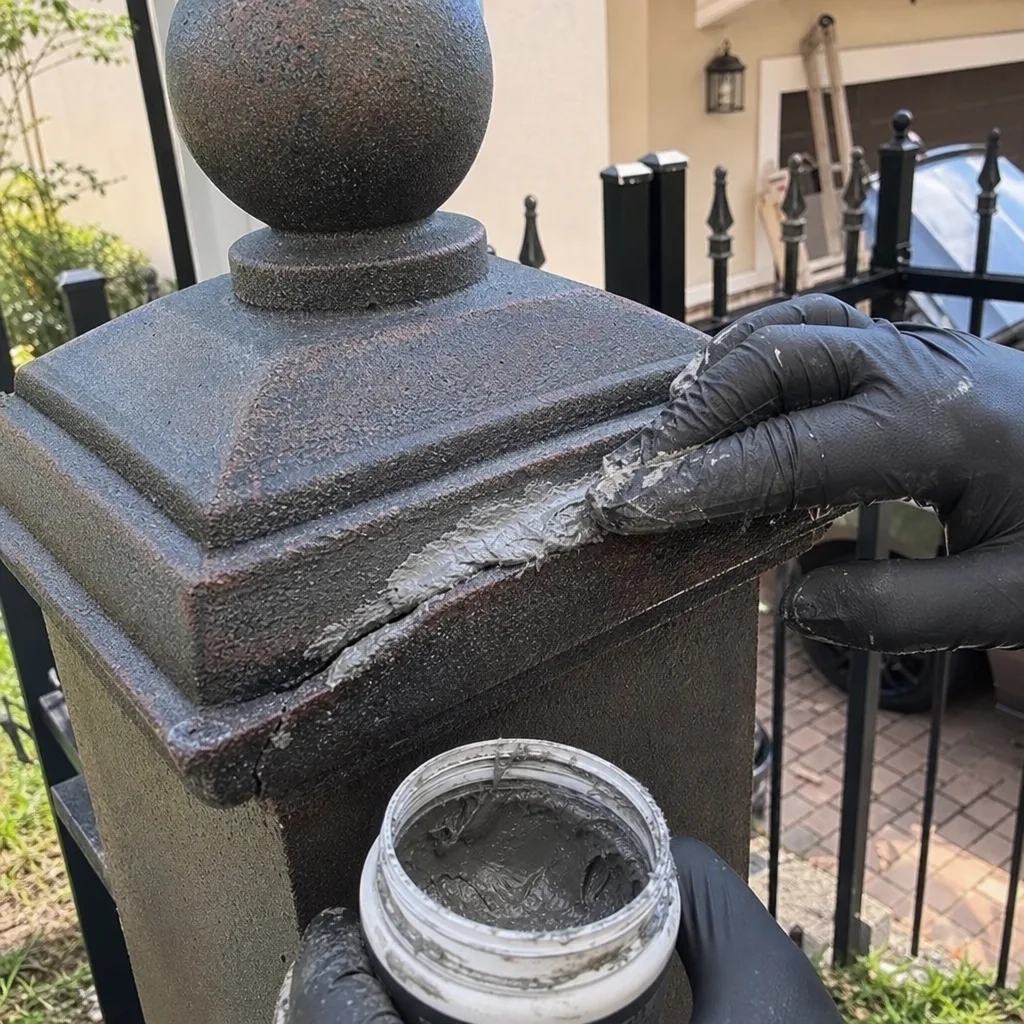 Gloved professional applying industrial sealant during gate repair service.